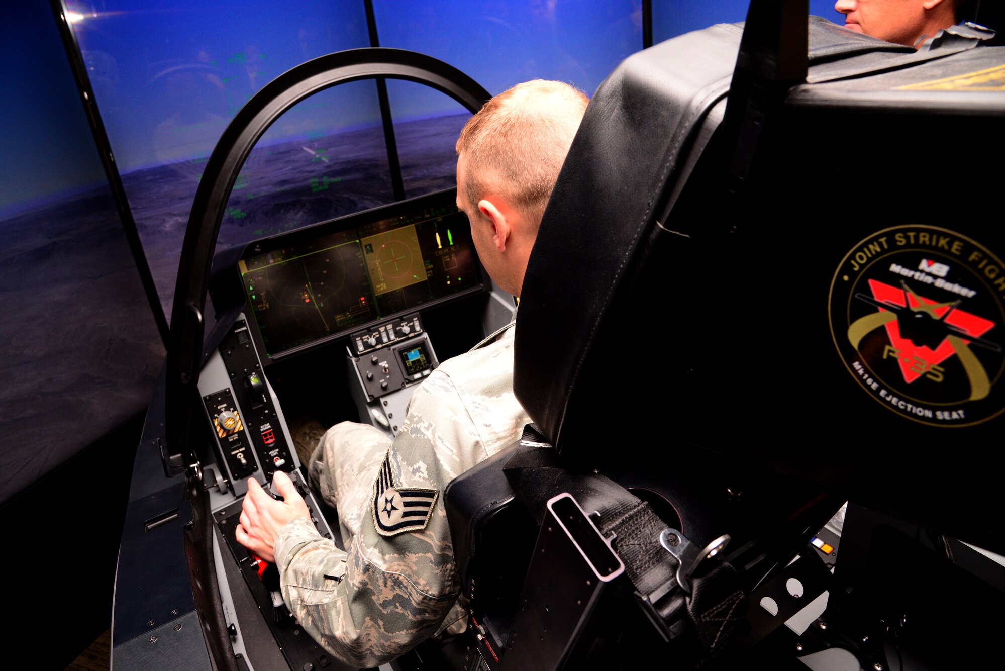 Staff Sgt. Joseph Howard, 51st Operations Support Squadron air traffic controller, sits inside the F-35 Lightning II demonstrator Oct. 8, 2015, at Osan Air Base, Republic of Korea. Members from across base were able to come out and experience what flying an F-35 would be like. (U.S. Air Force photo by Staff Sgt. Benjamin Sutton)