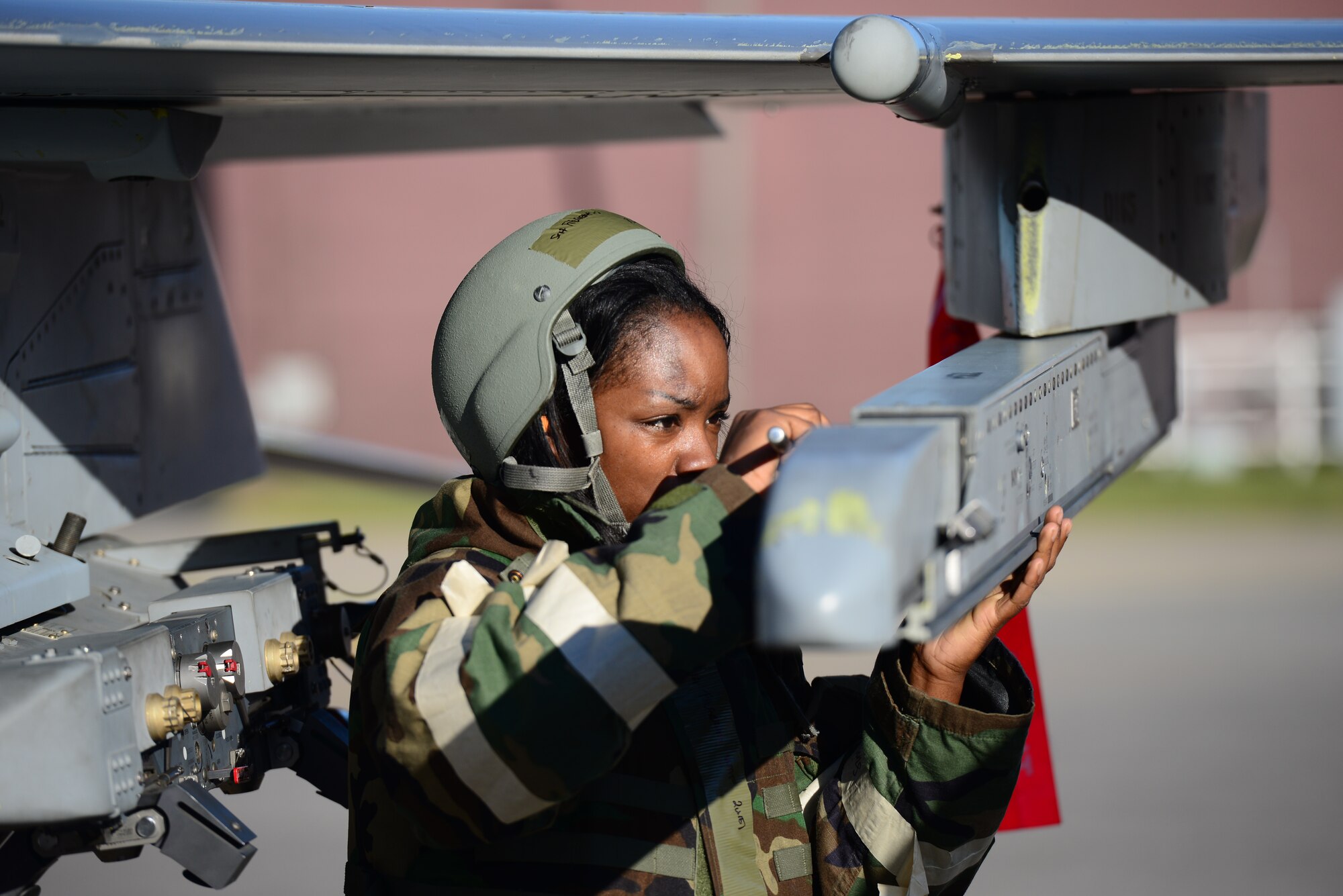 Senior Airman Kayla Fitzgerald, 36th Aircraft Maintenance Unit weapons loader, prepares an F-16 Fighting Falcon to receive practice munitions during the quarterly load competition held at Osan Air Base, Republic of Korea, Oct. 9, 2015. As part of their monthly qualification standards, weapons load crews from the 36th and 25th Aircraft Maintenance Units   go head-to-head, once a quarter, loading either an F-16 Fighting Falcon or an A-10 Thunderbolt II.
(U.S. Air Force photo/Staff Sgt. Amber Grimm)
