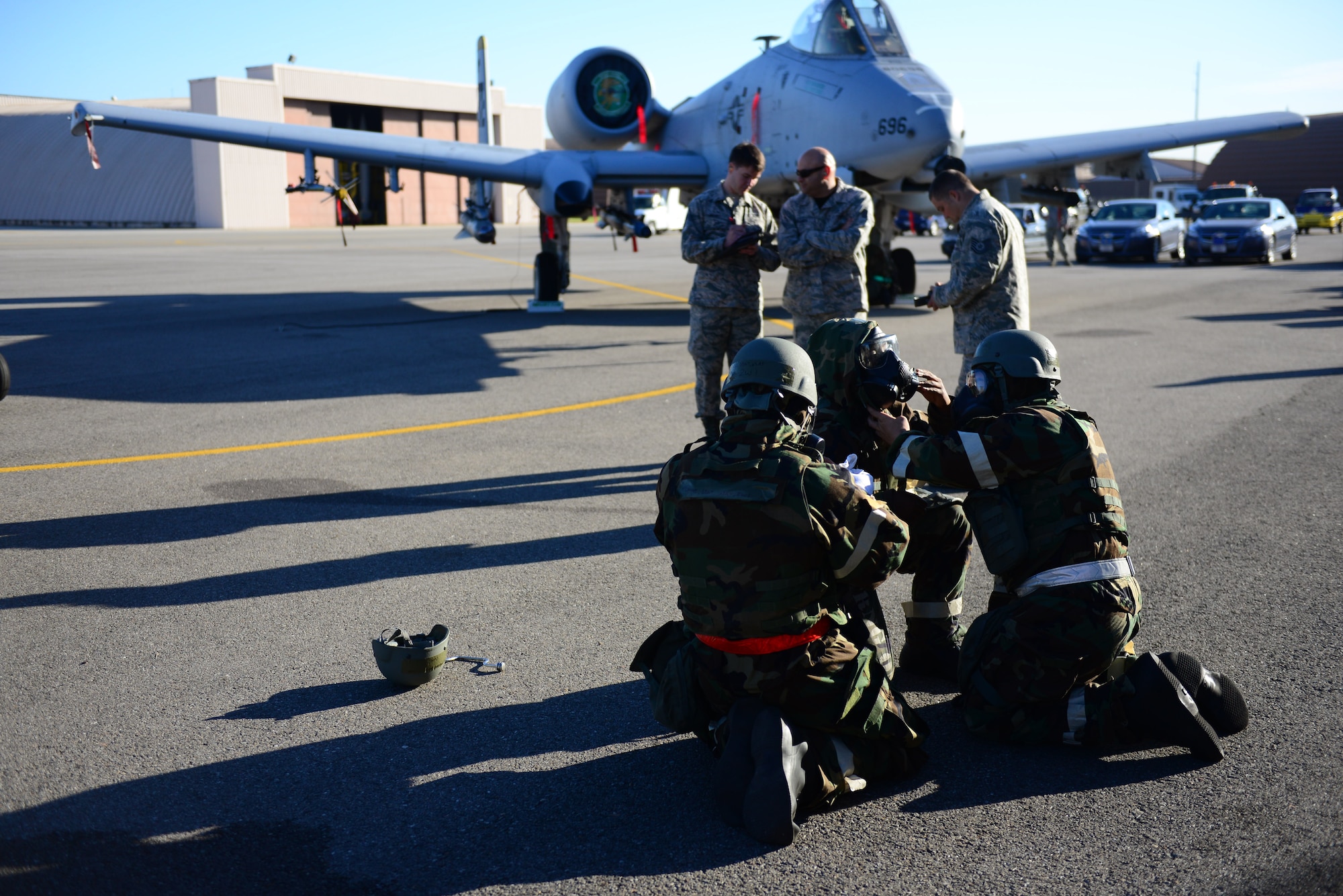 The 36th Aircraft Maintenance Unit load team performs buddy checks as a simulated gas attack is called in the middle of the quarterly load competition held at Osan Air Base, Republic of Korea, Oct. 9, 2015. As part of their monthly qualification standards, weapons load crews from the 36th and 25th Aircraft Maintenance Units   go head-to-head, once a quarter, reloading either an F-16 Fighting Falcon or an A-10 Thunderbolt II.  Each crew completes a written standards test and is timed when they reload simulated munitions onto their respective aircraft. 
(U.S. Air Force photo/Staff Sgt. Amber Grimm)