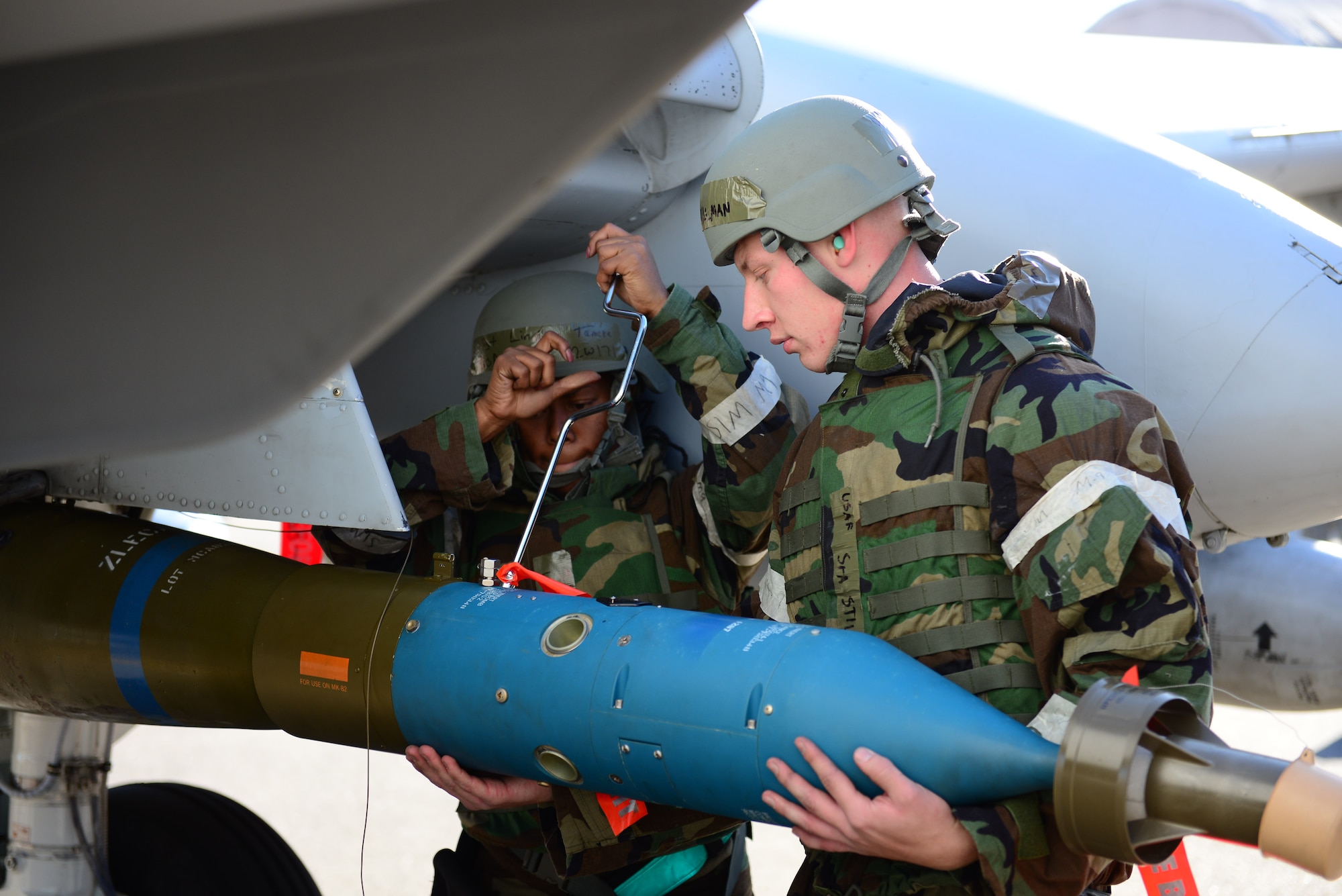 Staff Sgt. Tameka Lindsay and Senior Airman James Stillman, 25th Aircraft Maintenance Unit weapons loaders, complete the uploading of practice munitions during the quarterly load competition held at Osan Air Base, Republic of Korea, Oct. 9, 2015. The event adds an element of friendly rivalry to what is a qualification test for the technicians; competitors must complete a written test and a practical demonstration of skill within a fixed amount of time in order to maintain their mission readiness status. 
(U.S. Air Force photo/Staff Sgt. Amber Grimm)