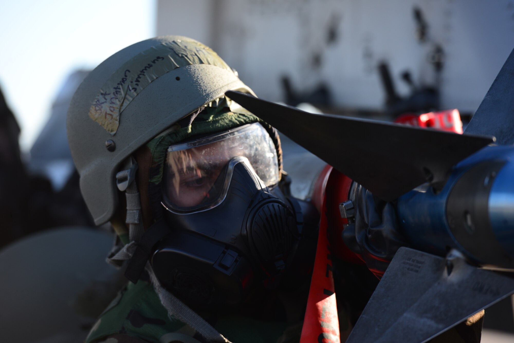 Senior Airman Jonathon Simmons, 25th Aircraft Maintenance Unit weapons loader, checks over and completes the loading of practice munitions in full mission-oriented protective postures gear during the quarterly load competition held at Osan Air Base, Republic of Korea, Oct. 9, 2015. The event adds an element of friendly rivalry to a qualification test for the technicians; competitors must complete a written test and a practical demonstration of skill within a fixed amount of time in order to maintain their mission readiness status. 
(U.S. Air Force photo/Staff Sgt. Amber Grimm)