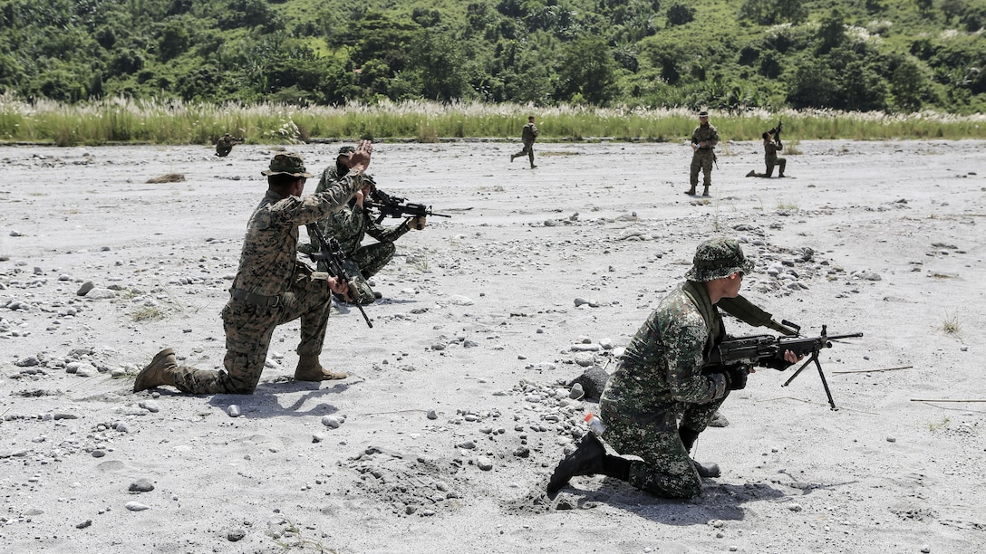 U.S. Marine Cpl. Alfredo Arroyo tells Philippine and U.S. Marines to move positions during a squad attack training at Crow Valley, Philippines, Oct. 4, 2015. Philippine Marines and U.S. Marines with Battalion Landing Team 2nd Battalion, 5th Marine Regiment, 31st Marine Expeditionary Unit, are training side by side for Amphibious Landing Exercise 2015, an annual bilateral training exercise conducted by members of the Armed Forces of the Philippines alongside U.S. Marine and Navy Forces. 