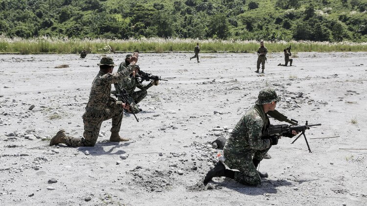 U.S. Marine Cpl. Alfredo Arroyo tells Philippine and U.S. Marines to move positions during a squad attack training at Crow Valley, Philippines, Oct. 4, 2015. Philippine Marines and U.S. Marines with Battalion Landing Team 2nd Battalion, 5th Marine Regiment, 31st Marine Expeditionary Unit, are training side by side for Amphibious Landing Exercise 2015, an annual bilateral training exercise conducted by members of the Armed Forces of the Philippines alongside U.S. Marine and Navy Forces. 