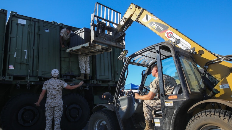 Marines with 1st Marine Logistics Group, 1st Marine Division, offload gear during a humanitarian assistance and disaster relief static display at Marina Green Park, San Francisco, Oct. 9, 2015, as part of San Francisco Fleet Week 2015. SFFW 15’ is a week-long event that blends a unique training and education program, bringing together key civilian emergency responders and Naval crisis-response forces to exchange best practices focused on humanitarian assistance disaster relief with particular emphasis on defense support to civil authorities.