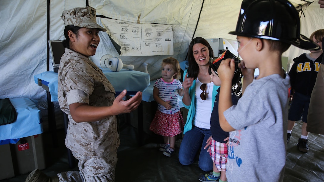 A sailor with 1st Medical Battalion, 1st Marine Logistics Group, interacts with young San Francisco children during a humanitarian assistance and disaster relief static display at Marina Green Park, San Francisco, Oct. 9, 2015, as part of San Francisco Fleet Week 2015. SFFW 15’ is a week-long event that blends a unique training and education program, bringing together key civilian emergency responders and Naval crisis-response forces to exchange best practices focused on humanitarian assistance disaster relief with particular emphasis on defense support to civil authorities.
