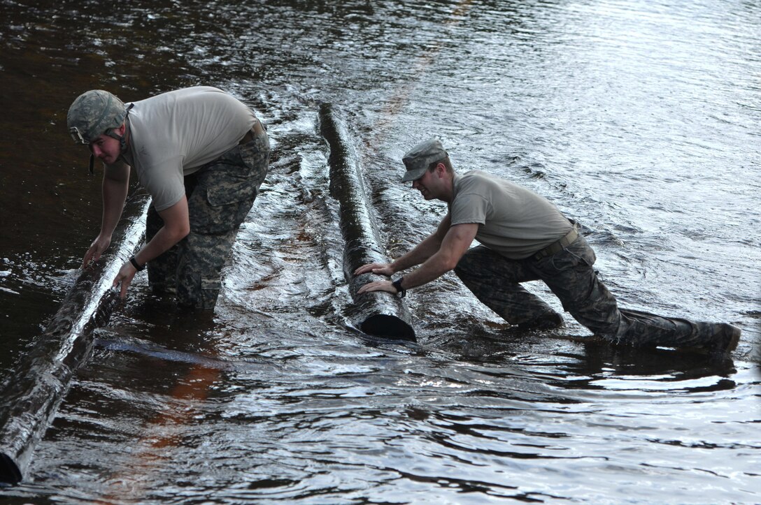 South Carolina Army National Guardsmen remove debris from flooded roads near Adams Run, S.C., Oct. 9, 2015, while assisting with statewide flood response. The soldiers are with Company C, 1st Battalion, 118th Infantry Regiment. South Carolina National Guard photo by Army Sgt. Joshua S. Edwards