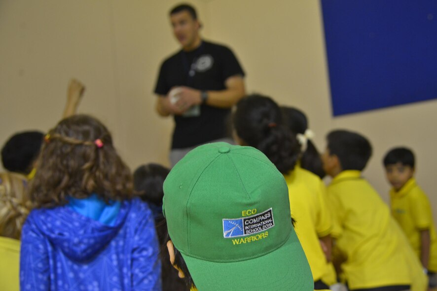 Technical Sgt. Brian Burmeister, 379th Expeditionary Civil Engineer Squadron firefighter, talks to children from Compass International School Doha about home fire alarm safety during Fire Prevention Week educational seminars October 8, 2015 in Doha, Qatar. During the visit, children were able to apply the skills taught and ask questions to further their learning.  (U.S. Air Force photo/Staff Sgt. Alexandre Montes)