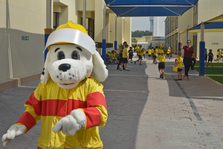 Sparky leaves the Compass International School Doha campus after visiting students for Fire Prevention Week exhibits held by the 379th Expeditionary Civil Engineer Squadron Fire Department October 8, 2015 in Doha, Qatar. Sparky is the National Fire Protection Association mascot and has promoted fire safety to children for more than 60 years. This year's Fire Prevention Week began with a proclamation signed by 379th Air Expeditionary Wing leadership and spanned Oct. 4 through the 11th. (U.S. Air Force photo/Staff Sgt. Alexandre Montes)