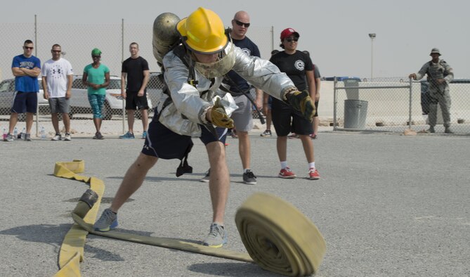 Service members deployed to Al Udeid Air Base, Qatar participated in the Fire Muster, a firefighter skills competition on Oct. 10, 2015. The competition featured numerous challenges for would-be fire fighters, including a skills obstacle course and water jousting. Nearly 100 people took part in the event, which organizers said was designed to provide people with an idea of what firefighters have to deal with on a regular basis. (U.S. Air Force Photo/Tech. Sgt. James Hodgman)