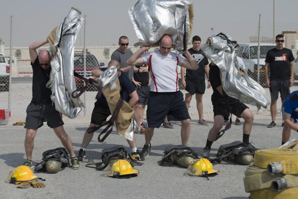Service members deployed to Al Udeid Air Base, Qatar participated in the Fire Muster, a firefighter skills competition on Oct. 10, 2015. The competition featured numerous challenges for would-be fire fighters, including a skills obstacle course and water jousting. Nearly 100 people took part in the event, which organizers said was designed to provide people with an idea of what firefighters have to deal with on a regular basis. (U.S. Air Force Photo/Tech. Sgt. James Hodgman)
