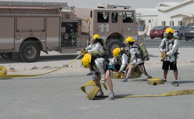 Service members deployed to Al Udeid Air Base, Qatar participated in the Fire Muster, a firefighter skills competition on Oct. 10, 2015. The competition featured numerous challenges for would-be fire fighters, including a skills obstacle course and water jousting. Nearly 100 people took part in the event, which organizers said was designed to provide people with an idea of what firefighters have to deal with on a regular basis. (U.S. Air Force Photo/Tech. Sgt. James Hodgman)