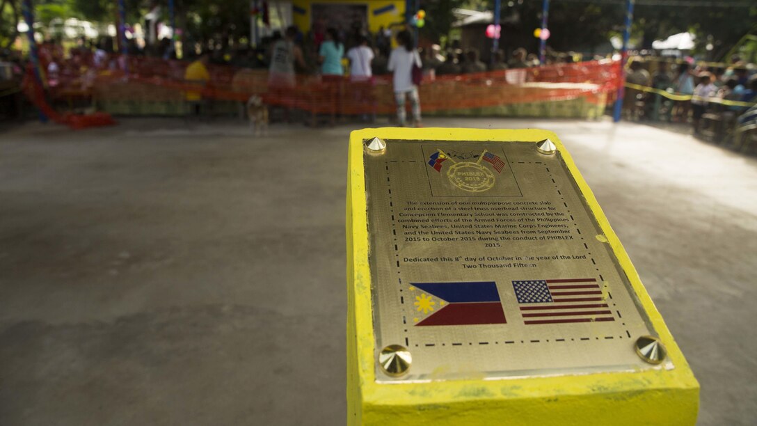 A plaque has been placed at the project site in remembrance or the work done by the Marines of 9th Engineer Support Battalion at Concepcion Elementary School Oct. 8, during Amphibious Landing Exercise 2015, in Puerta Princesa, Philippines. PHIBLEX is an annual, bilateral training exercise conducted by members of the Armed Forces of the Philippines alongside U.S. Marine and Navy Forces. It focuses on strengthening the partnership and relationships between the two nations across a range of military operations, including disaster relief and complex expeditionary operations. The ribbon cutting ceremony signified the end of the Humanitarian Civic Assistance projects at the Concepcion and Binduyan Elementary schools. (U.S. Marine photo by Cpl. Robert Williams Jr./Released)