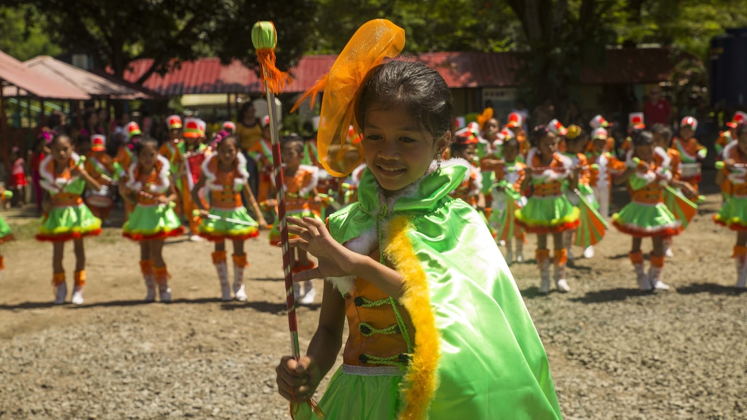 Binduyan Elementary School students perform during an intermission at the ribbon cutting ceremony Oct. 8, in Puerta Princesa, Philippines, during Amphibious Landing Exercise 2015. PHIBLEX is an annual, bilateral training exercise conducted by members of the Armed Forces of the Philippines alongside U.S. Marine and Navy Forces. It focuses on strengthening the partnership and relationships between the two nations across a range of military operations, including disaster relief and complex expeditionary operations. The ribbon cutting ceremony signified the end of the Humanitarian Civic Assistance projects at the Concepcion and Binduyan Elementary schools. (U.S. Marine photo by Cpl. Robert Williams Jr./Released)