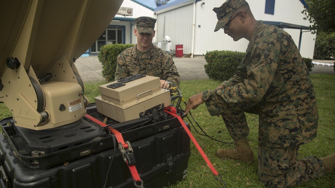 Cpl. Wesley McCulloch, left, and Cpl. Jake Morales troubleshoot a Hawkeye III Lite satellite at Clark Air Base, Philippines, Oct. 6, 2015. Communication Marines are a vital link to the command and provided 3rd Marine Expeditionary Brigade with communications throughout Amphibious Landing Exercise 2015. PHIBLEX 2015 is an annual, bilateral training exercise conducted by U.S. Marine and Navy Forces with the Armed Forces of the Philippines in order to strengthen our interoperability and working relationships across the range of military operations — from disaster relief, to complex expeditionary operations. Morales from Philadelphia, Pennsylvania, is a data network specialist with 7th Communications Battalion, III Marine Headquarters Group, III Marine Expeditionary Force. McCulloch, from Dyersburg, Tennessee, is a field radio operator with 7th Comm Bn., III MHG, III MEF. (U.S. Marine Corps photo by Cpl. Joey S. Holeman, Jr./ Released)