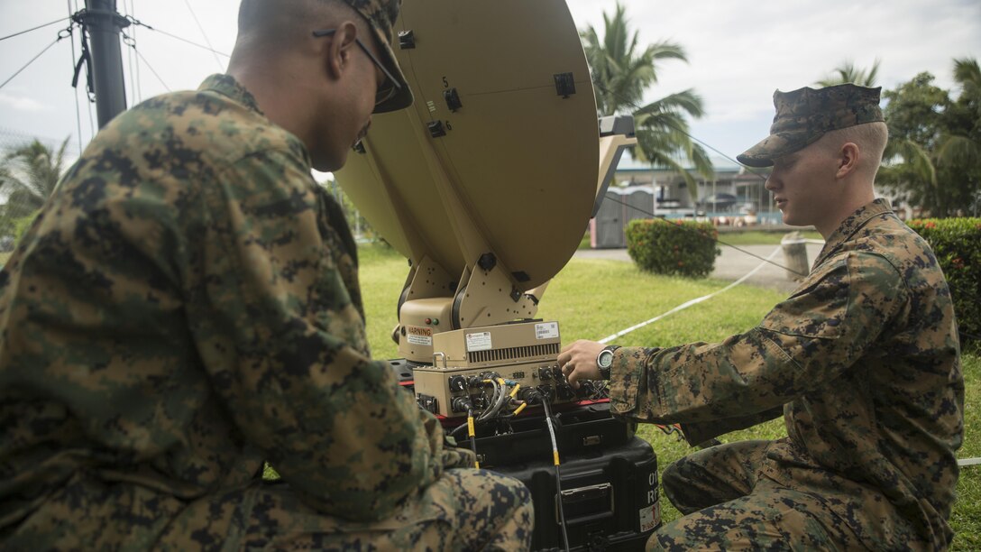 Cpl. Jake Morales, left, and Cpl. Wesley McCulloch troubleshoot a Hawkeye III Lite satellite at Clark Air Base, Philippines, Oct. 6, 2015. Communication Marines are a vital link to the command and provided 3rd Marine Expeditionary Brigade with communications throughout Amphibious Landing Exercise 2015. PHIBLEX 2015 is an annual, bilateral training exercise conducted by U.S. Marine and Navy Forces with the Armed Forces of the Philippines in order to strengthen our interoperability and working relationships across the range of military operations — from disaster relief, to complex expeditionary operations. Morales from Philadelphia, Pennsylvania, is a data network specialist with 7th Communications Battalion, III Marine Headquarters Group, III Marine Expeditionary Force. McCulloch, from Dyersburg, Tennessee, is a field radio operator with 7th Comm Bn., III MHG, III MEF. (U.S. Marine Corps photo by Cpl. Joey S. Holeman, Jr./ Released)