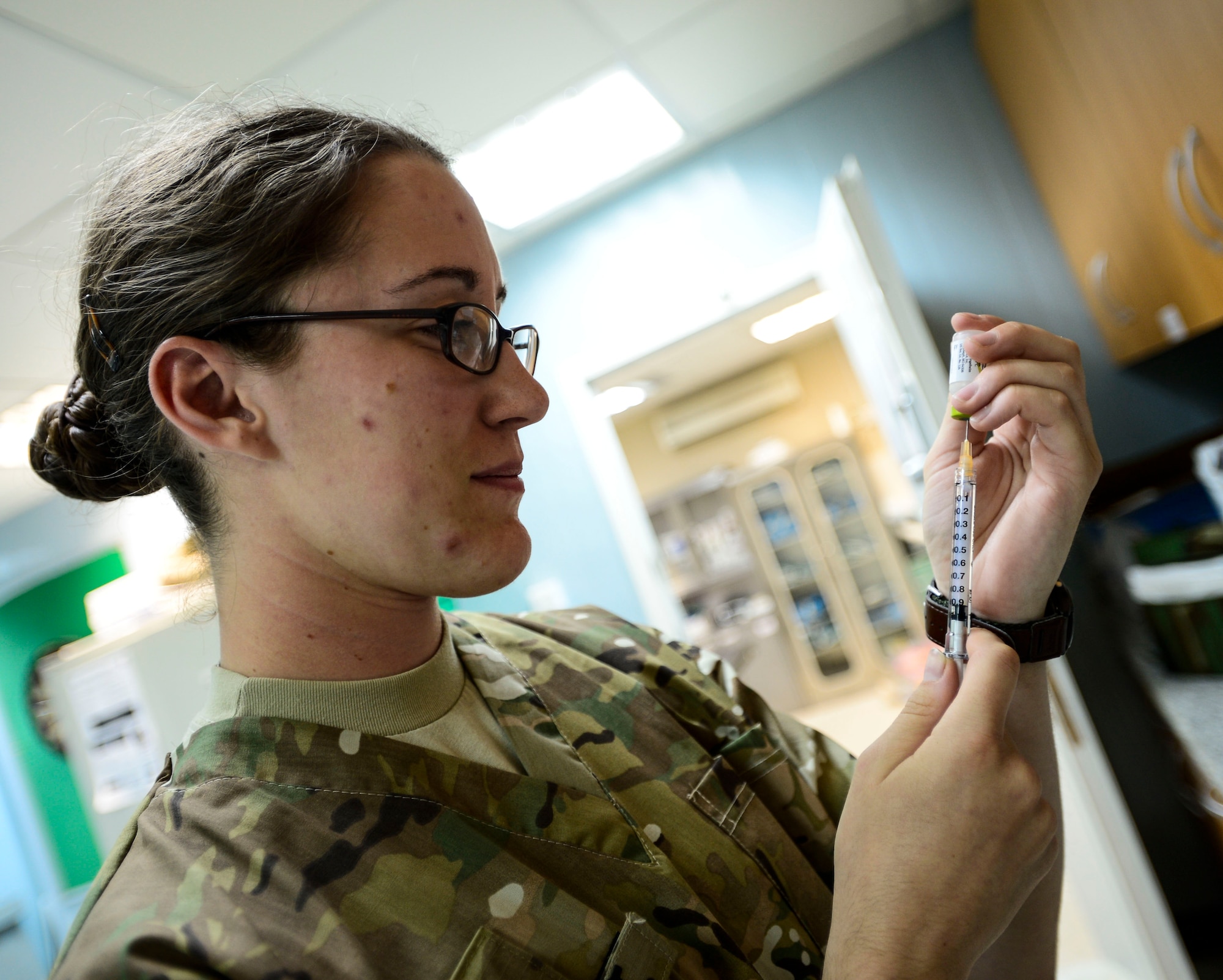 U.S. Army Private 1st Class Chelsey Therault, 463rd Military Detachment Veterinary Service veterinary technician, prepares a vaccination syringe at an undisclosed location in Southwest Asia, Sept. 28, 2015. Just like humans, vaccinating animals helps protect them against several serious and life threatening diseases. (U.S. Air Force photo by Senior Airman Racheal E. Watson/Released)