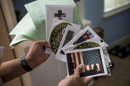 Ilda Laboy, mother of Spc. Nicolas Laboy, U.S. Army Reserve information technology specialist for the 416th Theater Engineer Command, holds several cards and letters they received after Laboy was in a motorcycle accident three months earlier. Laboy is expected to walk again after three more months of physical therapy. During his accident, Laboy broke his right leg, received a third-degree burn in his left thigh, severed his kidney and liver, fractured his lower spine and his right shoulder, and suffered internal bleeding in his brain. (U.S. Army photo by Master Sgt. Michel Sauret)