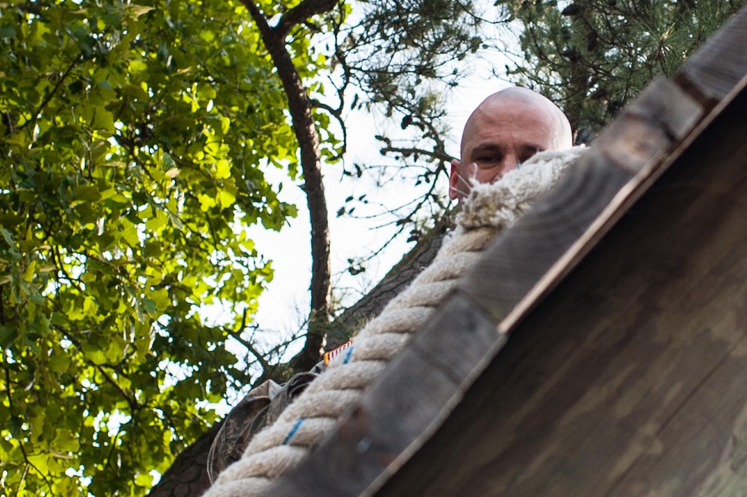 Sgt. 1st Class Keith Johnson, representing the U.S. Army Reserve Careers Division, completes an obstacle at the "Little Nasty Nick" obstacle course at the 2015 U.S. Army Reserve Best Warrior Competition at Fort Bragg, N.C., May 6. This year's Army Reserve Best Warrior Competition will determine the top noncommissioned officer and junior enlisted Soldier who will represent the Army Reserve in the Department of the Army Best Warrior competition in October at Fort Lee, Va. (U.S. Army photo by Timothy L. Hale/Released)