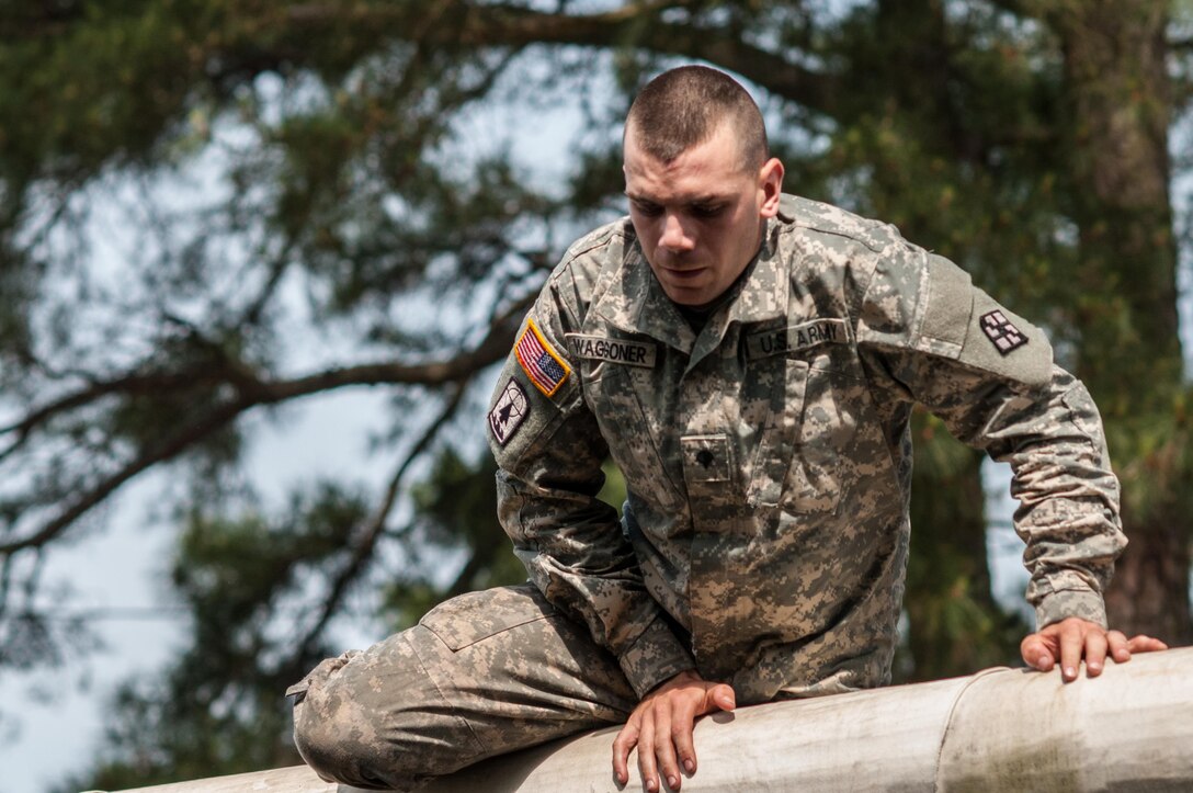 Spc. Robert Waggoner, representing the 412th Theater Engineer Command, completes an obstacle at the "Little Nasty Nick" obstacle course at the 2015 U.S. Army Reserve Best Warrior Competition at Fort Bragg, N.C., May 6. This year's Army Reserve Best Warrior Competition will determine the top noncommissioned officer and junior enlisted Soldier who will represent the Army Reserve in the Department of the Army Best Warrior competition in October at Fort Lee, Va. (U.S. Army photo by Timothy L. Hale/Released)