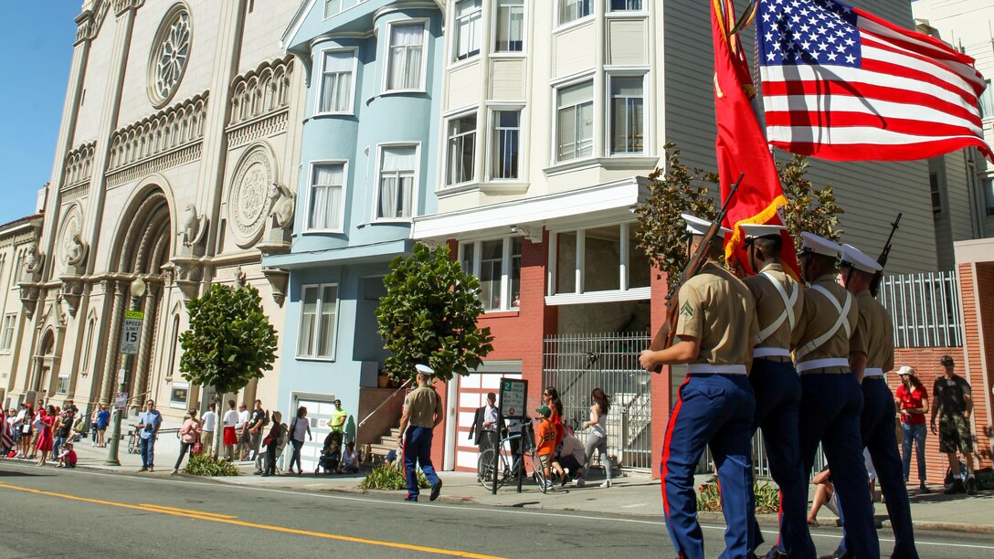 A Marine Corps color guard marches during the Italian heritage parade on Oct. 11, as part of San Francisco Fleet Week 2015. SFFW '15 is a week-long event that blends a unique training and education program, bringing together key civilian emergency responders and Naval crisis-response forces to exchange best practices on humanitarian assistance disaster relief with particular emphasis on defense support to civil authorities.
