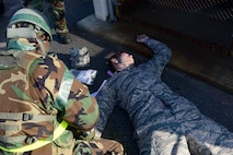 Post attack recovery par team Airmen administer self-aid buddy and care as a result from a missile fire exercise as part of Beverly Pack 16-1 at Kunsan Air Base, Republic of Korea, Oct. 6, 2015. The exercise tested the ability of Airmen to respond to a real world self-aid and buddy care crisis. (U.S. Air Force photo by Senior Airman Ashley L. Gardner/Released)

