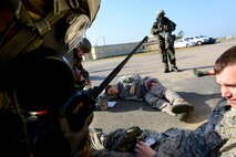 An 8th Logistics Readiness Squadron Airman radios to the unit control center to report casualty information during a missile fire exercise as part of Beverly Pack 16-1 at Kunsan Air Base, Republic of Korea, Oct. 6, 2015. The casualty information is sent to know how much further help is required for the injured individuals. (U.S. Air Force photo by Senior Airman Ashley L. Gardner/Released)

