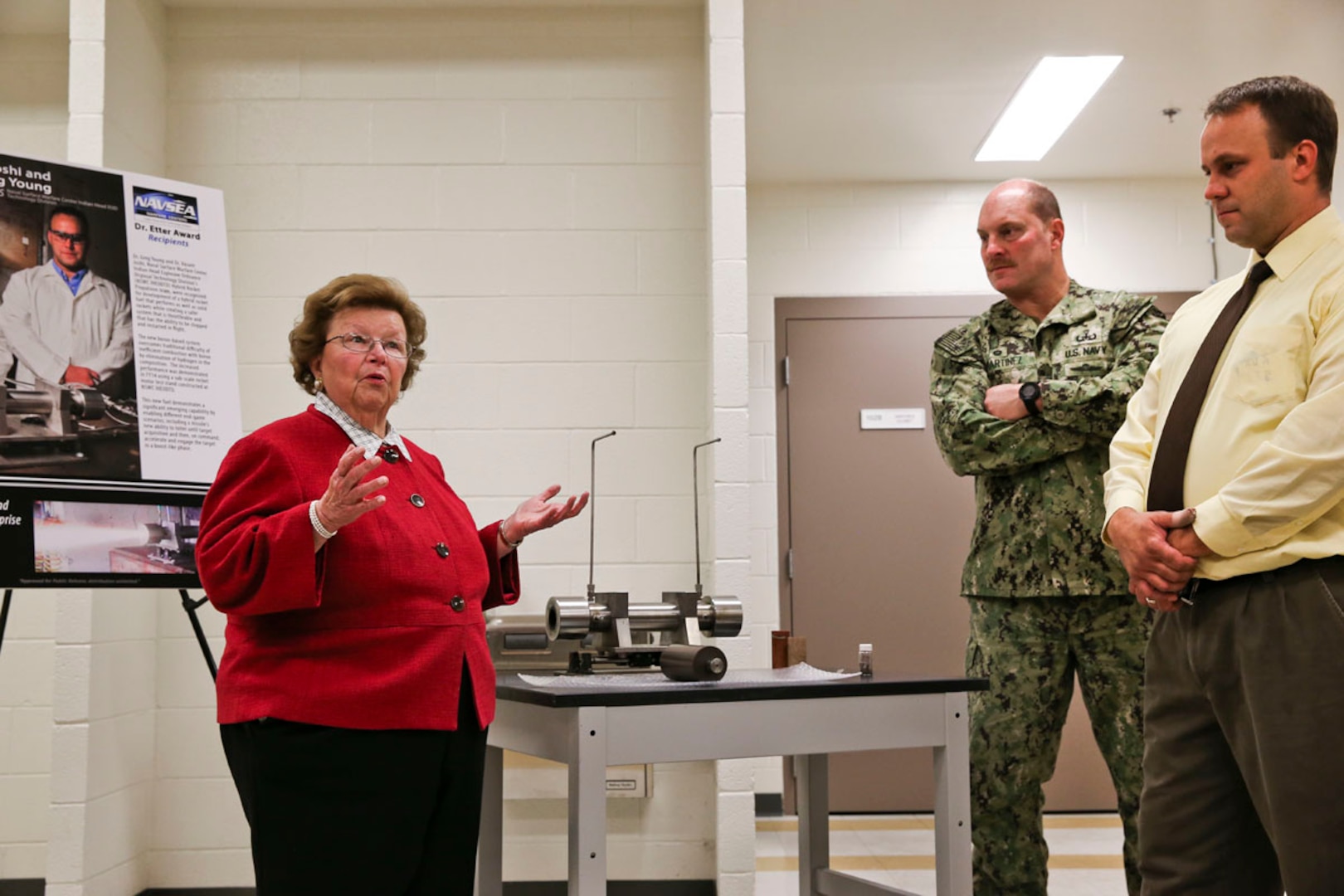 U.S. Senator Barbara A. Mikulski (D-Md.) learns about the command's Hybrid Rocket Propulsion efforts from propulsion engineer and program lead Dr. Greg Young, shown with Commanding Officer Capt. Vincent Martinez, during her visit to Naval Surface Warfare Center Indian Head Explosive Ordnance Disposal Technology Division (NSWC IHEODTD), Oct. 5. 