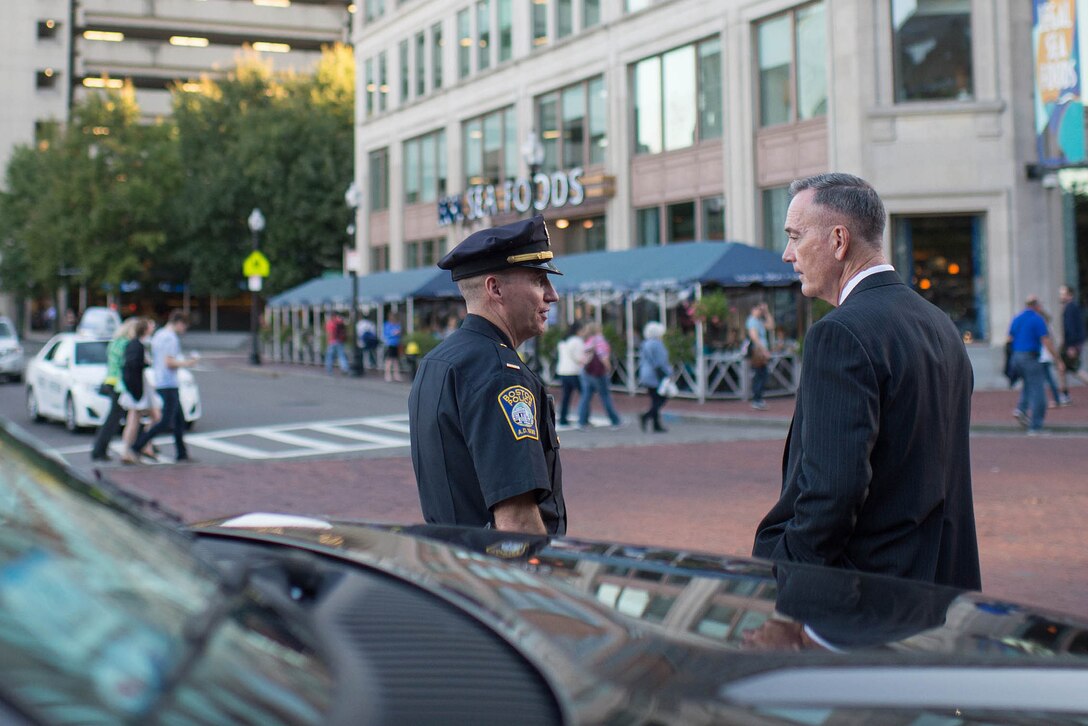 U.S. Marine Corps Gen. Joseph F. Dunford Jr., left, chairman of the Joint Chiefs of Staff, and a Boston policeman talk in Boston, Oct. 12, 2015. Dunford was in Boston to attend the Australia-United States Ministerial Consultations along with U.S. Defense Secretary Ash Carter. 