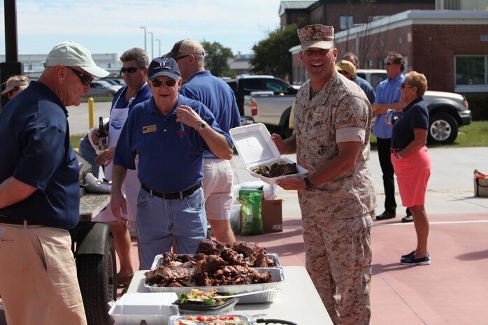 Lt. Col. Travis L. Powers shows off the meal he prepared at the Fall Chicken Picking at Marine Corps Air Station Cherry Point, North Carolina, Oct. 7, 2015. The event was held to enhance relationships between the New Bern community and the Marines and Sailors at the air station. Powers is the Marine Corps Air Station Cherry Point executive officer. (U.S. Marine Corps photo by Pfc. Nicholas P. Baird/ Released)