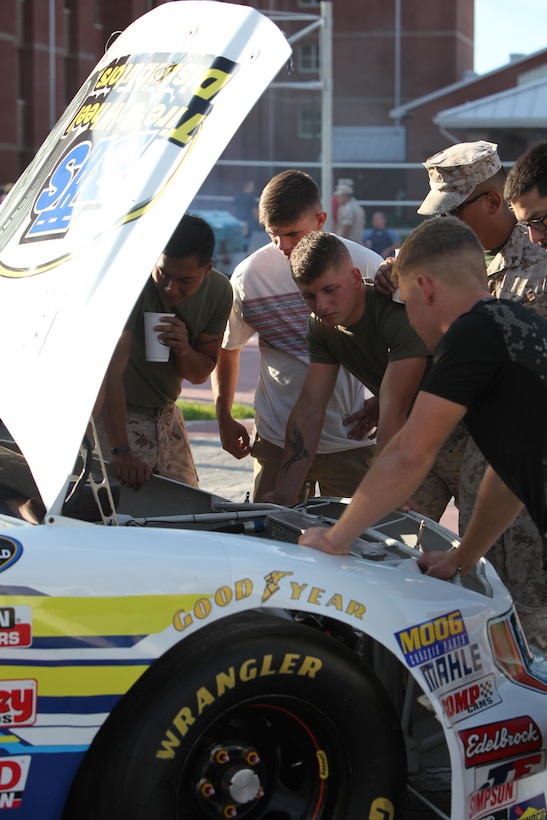 Marines check out the engine of the Black’s Tire and Services race car during the Fall Chicken Picking at Marine Corps Air Station Cherry Point, North Carolina, Oct. 7, 2015. The event was held to enhance relationships between the New Bern community and the service members at the air station. (U.S. Marine Corps photo by Pfc. Nicholas P. Baird/ Released)