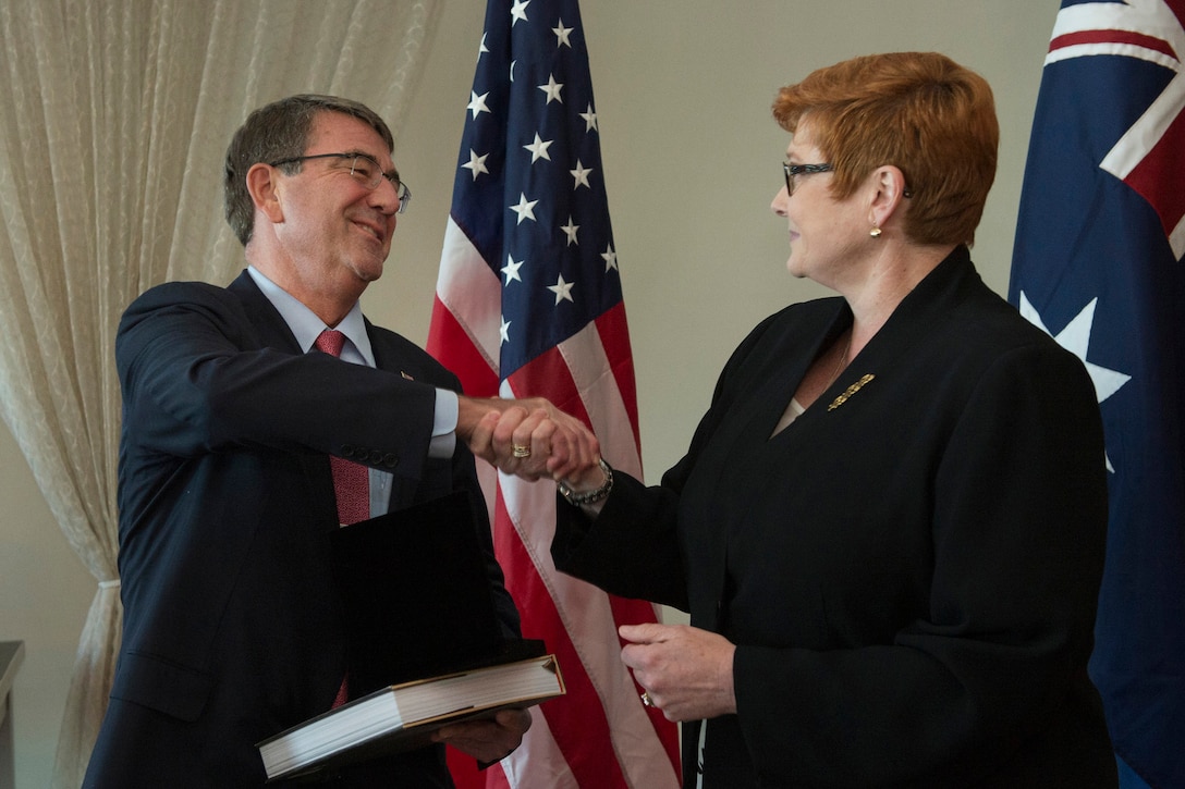 Australian Defense Minister Marise Payne, right, presents U.S. Defense Secretary Ash Carter with a gift after the two leaders met in Boston during the Australia–United States Ministerial Consultations in Boston, Oct. 12, 2015. The two leaders discussed matters of mutual importance. DoD photo by Air Force Senior Master Sgt. Adrian Cadiz