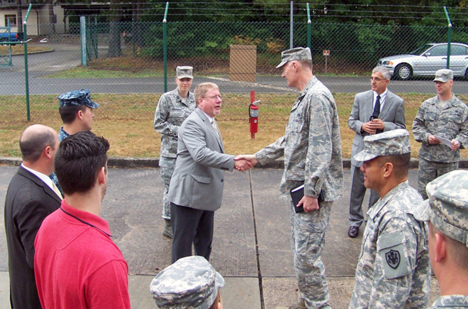 Defense Logistics Agency Director Air Force Lt. Gen. Andy Busch is greeted by Lanny Collums, DLA Energy Europe & Africa Quality Chief in Kaiserslautern, Germany, during a visit to the field activity Aug. 14. Photo by Navy Lt. Joseph Landon