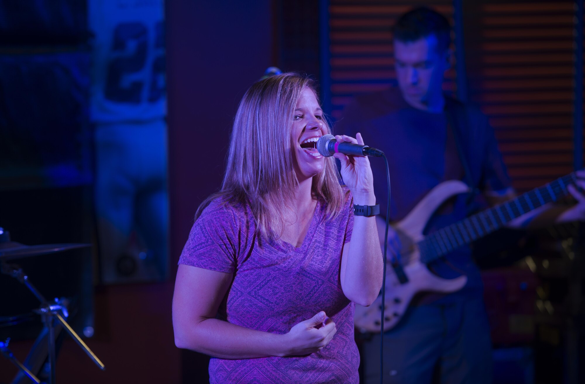 Senior Airman Melissa Lackore, a vocalist with the U.S. Air Force’s Central Command Band, Full Spectrum, performs at the Fox Sports Lounge at Al Udeid Air Base, Qatar Oct. 13, 2015. The performance was the band’s last before the group kicks off a 16-day tour. During the show, which featured hit songs “Uptown Funk,” “Beat It” and “Superstitious” the group was greeted by loud cheers from the audience. (U.S. Air Force Photo/Tech. Sgt. James Hodgman)