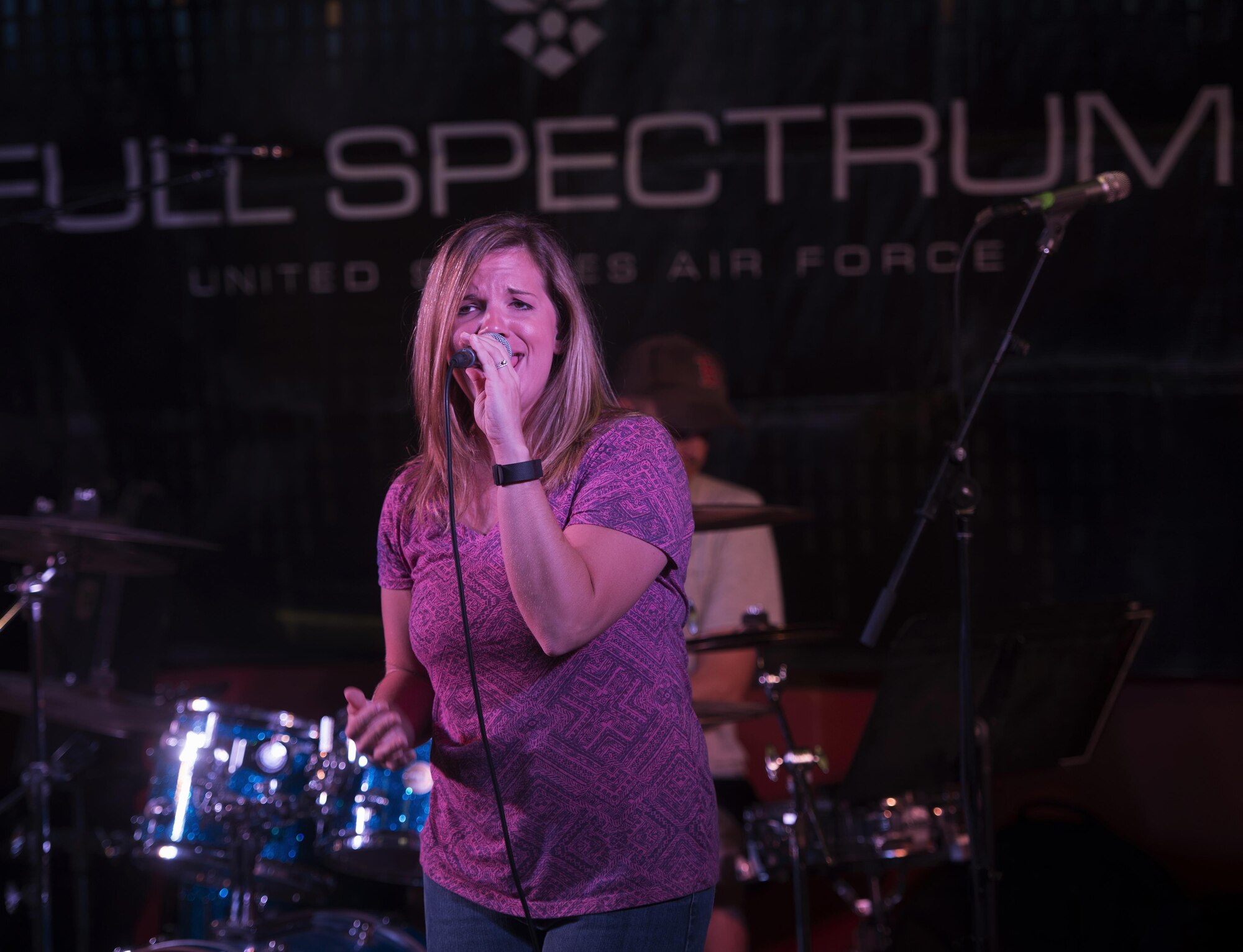 Senior Airman Melissa Lackore, a vocalist with the U.S. Air Force’s Central Command Band, Full Spectrum, performs at the Fox Sports Lounge at Al Udeid Air Base, Qatar Oct. 13, 2015. The performance was the band’s last before the group kicks-off a 16-day tour. During the show, which featured hit songs “Uptown Funk” and “Beat It,” the group was greeted by loud cheers from the audience. (U.S. Air Force Photo/Tech. Sgt. James Hodgman)