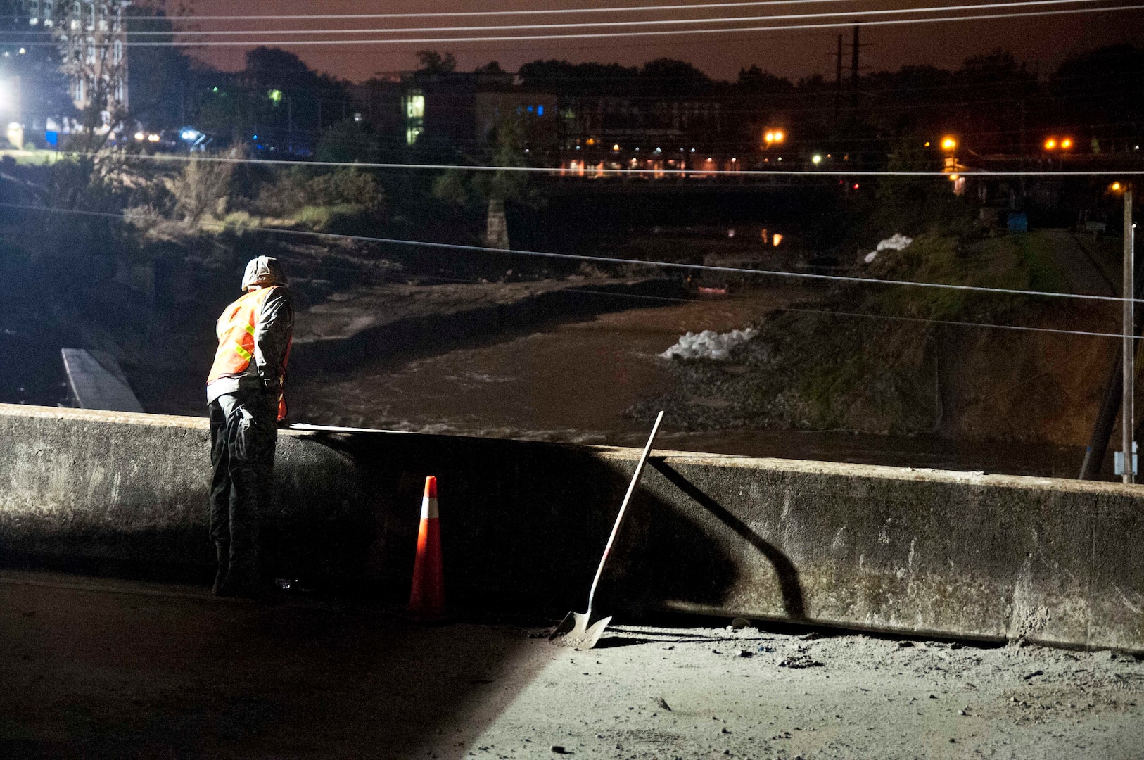 A North Carolina National Guard Soldier assigned to the 875th Engineer Company looks over the bridge, onto the damaged canal where rocks are being placed to create a temporary dam in Columbia, South Carolina, Oct. 11, 2015. The NCNG has been ready to support the South Carolina Emergency Management Division and other state and federal partner agencies as South Carolina recovers from the effects of extended rain downfall, causing severe flooding throughout the state. 