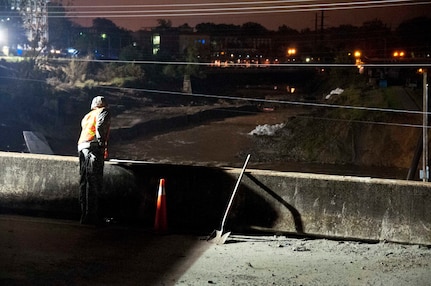 A North Carolina National Guard Soldier assigned to the 875th Engineer Company looks over the bridge, onto the damaged canal where rocks are being placed to create a temporary dam in Columbia, South Carolina, Oct. 11, 2015. The NCNG has been ready to support the South Carolina Emergency Management Division and other state and federal partner agencies as South Carolina recovers from the effects of extended rain downfall, causing severe flooding throughout the state. 