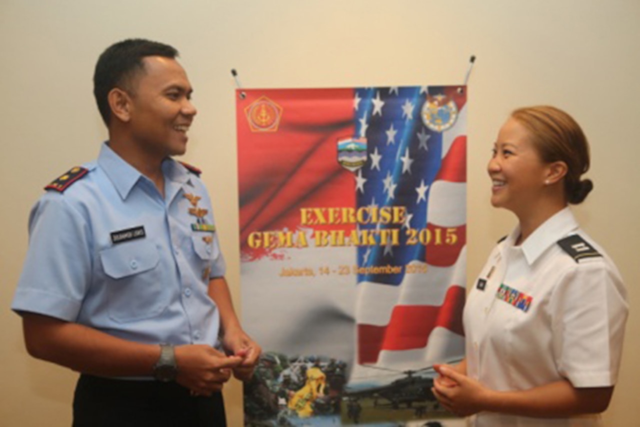 U.S. Army Capt. Michelle Sukardi Kania and Maj. Zulhamidi Lubis of the Indonesian air force discuss the similarities and differences between Indonesian and U.S. military forces during Exercise Gema Bhakti in Jakarta, Indonesia, Sept. 16, 2015. U.S. Marine Corps photo by 2nd Lt. Michael Maggitti