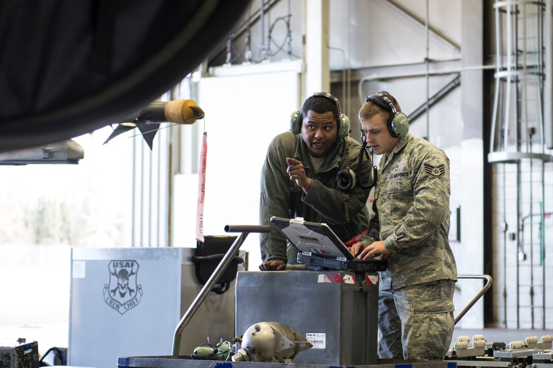 Senior Airman Terrence Lawrence and Staff Sgt. Eric Fitch, both 354th Aircraft Maintenance Squadron maintenance specialists, troubleshoot an F-16 Fighting Falcon assigned to the 18th Aggressor Squadron at Eielson Air Force Base, Alaska, Oct. 7, 2015. Lawrence was the first Airman to complete a program called Cut Training, which cross utilizes Airmen to fill undermanned crew chief positions. (U.S. Air Force photo/Staff Sgt. Joshua Turner)