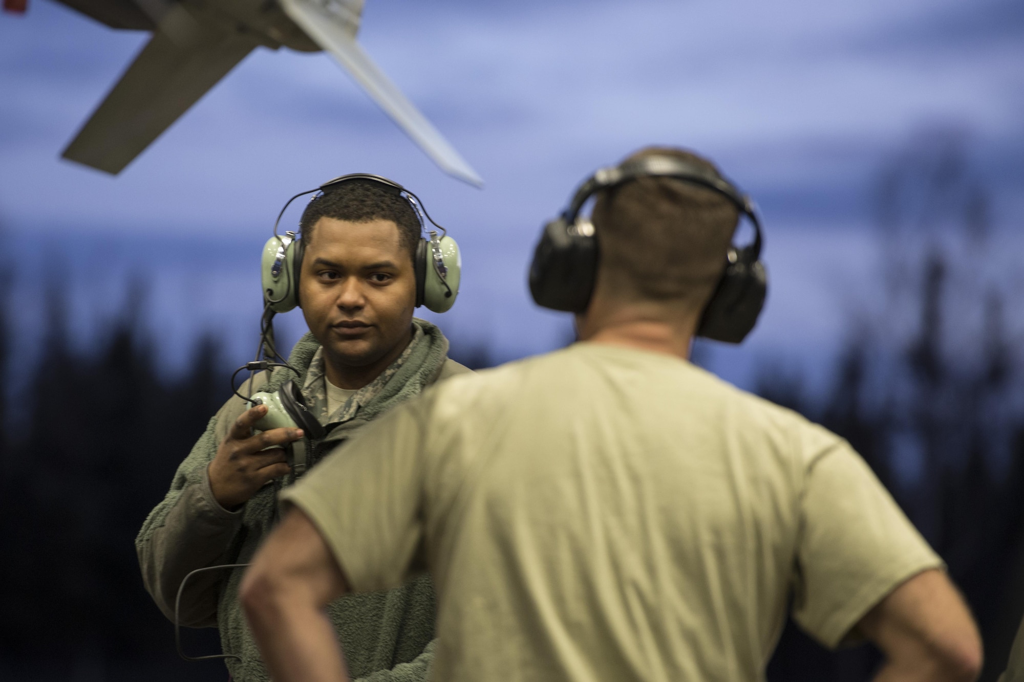 Senior Airman Terrence Lawrence, a 354th Aircraft Maintenance Squadron aircraft electrical and environmental systems journeyman, receives advice from Tech. Sgt. Glen Rathburn, a 354th AMXS maintainer, under the wing of an F-16 Fighting Falcon assigned to the 18th Aggressor Squadron at Eielson Air Force Base, Alaska, Oct. 8, 2015. Lawrence is cross utilized from a different maintenance career field to perform crew chief tasks due to crew chiefs 50 percent manning. (U.S. Air Force photo/Staff Sgt. Joshua Turner)