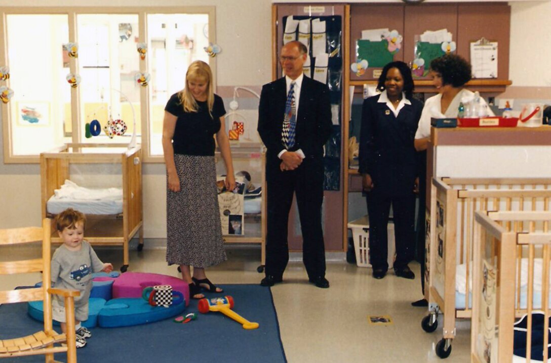 Defense Logistics Agency Child Development Center staffers watch over some of the first occupants in the infant room at the grand opening of the center in August 1998. 