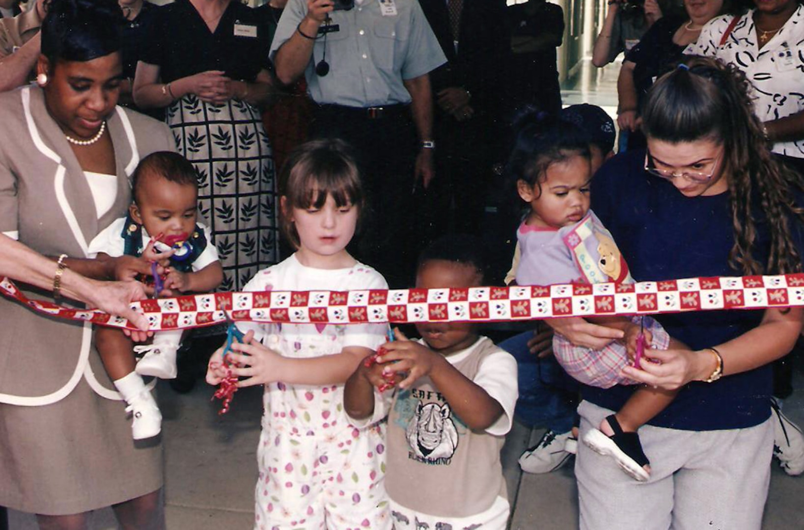 Five-year-old Amanda Shaw (center) helps cut the ribbon at the grand opening of the Defense Logistics Agency’s Child Development Center in August 1998. Amanda, the daughter of DLA Finance employee Joe Shaw, and her younger sister Megan were some of the first enrollees at the center.