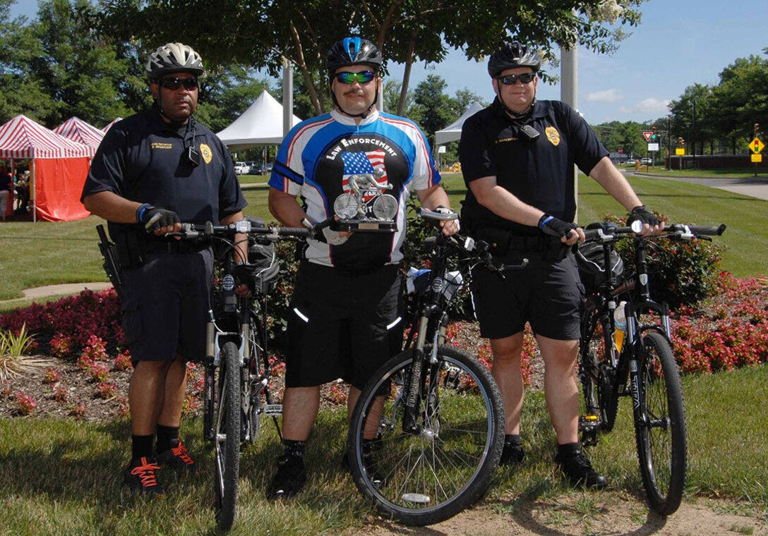 DLA Police Sgt. James Sprecher, center, and other members of the DLA Police bike team display the trophy Sprecher received for participating in the 250-mile Law Enforcement United Road to Hope, pose during the McNamara Headquarters Complex Family Day June 24. 