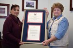 Anna Richar, left, Horsham Air Guard Station’s Airman & Family Readiness Center program manager, holds the President’s Volunteer Service Award alongside Jenny Papas, Friends of the Family Readiness Group president Oct. 4, 2015, at the Wing headquarters building, Horsham Air Guard Station, Pennsylvania. Richar earned the accolades for her work with veterans and military families in 2014. 