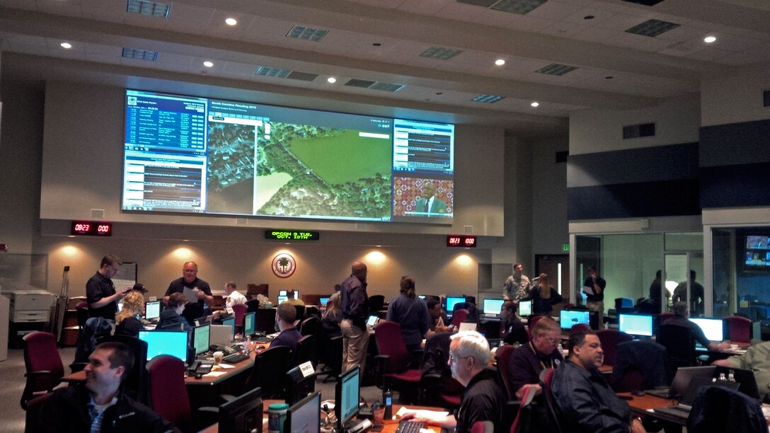 Doug Weber, Seattle District Emergency Management chief, was called to South Carolina as a subject matter expert in infrastructure assessment. The U.S. Army Corps of Engineers, Headquarters, has been tasked to assess 652 non-federal dams to determine the extent of damages following recent flooding there. Weber is also working with the Federal Emergency Management Agency to develop a wastewater treatment facility assessment plan. There are 74 wastewater treatment plants that have reported flood damage. The Corps also completed an Unmanned Aerial System mission, which is the first time the UAS has been used by USACE for a FEMA mission. The photo shows those who have come together from across the country to support the mission in the South Carolina state-run Emergency Operations Center.