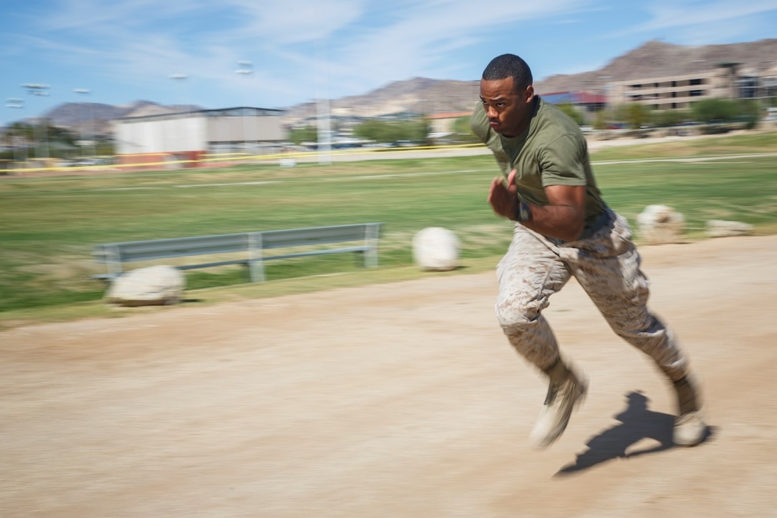 Corporal Joshua Boozer, an ammunition technician assigned to Company B, 1st Tank Battalion, 1st Marine Division, sprints on a track aboard Marine Corps Air Ground Combat Center Twentynine Palms, Calif., Oct. 7, 2015. Boozer participated and won the U.S. Marine Corps High Intensity Tactical Training Ultimate Tactical Athlete Championship. (U.S. Marine Corps photo by Lance Cpl. Levi Schultz)