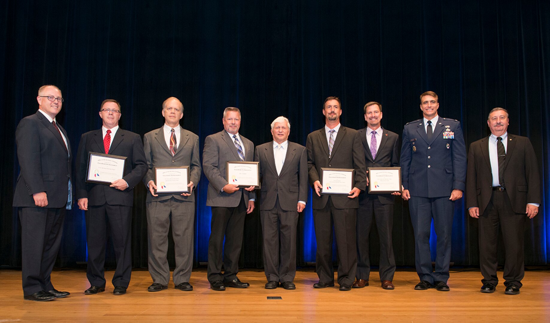 Stephen Welby, deputy assistant secretary of defense for systems engineering, left, poses with the DLA Value Engineering Achievement Award winners. The Department of Defense presented the FY 2014 Department of Defense Value Engineering Achievement Awards during a ceremony at the Pentagon, Washington, D.C., June 25, 2015. 