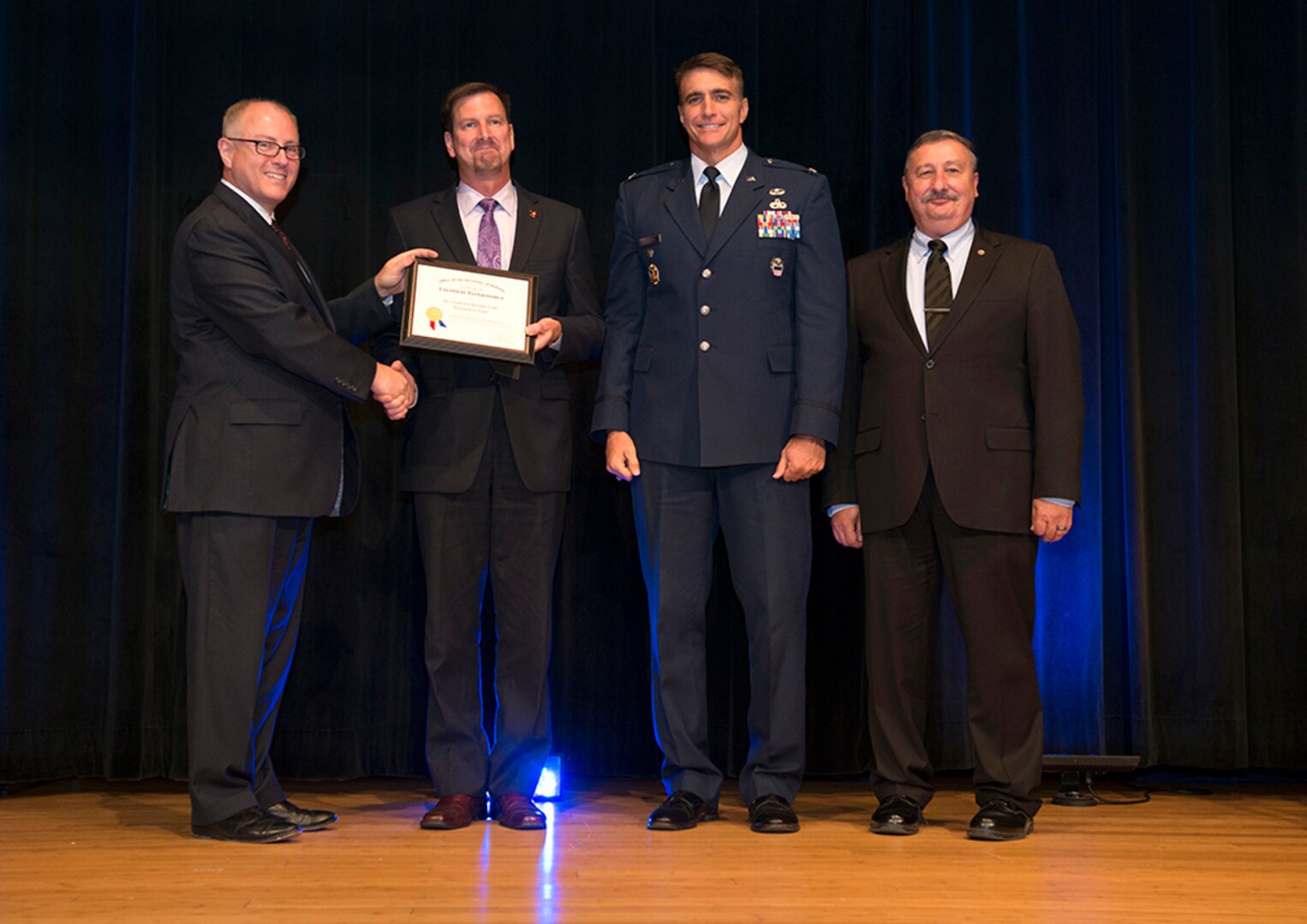 Stephen Welby, deputy assistant secretary of defense for systems engineering, left, poses with the DoD Value Engineering Achievement Award winners from DLA Land and Maritime: Todd Jenkins and Air Force Col. Michael Tannehill, along with Ted Case, DLA vice director. The Department of Defense presented the FY 2014 Department of Defense Value Engineering Achievement Awards during a ceremony at the Pentagon, Washington, D.C., June 25, 2015. 