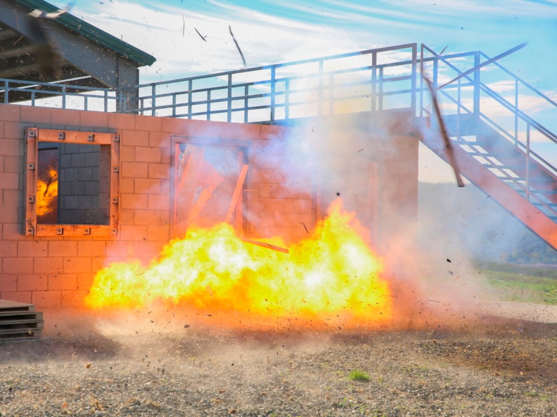 Marines with Company B, 1st Combat Engineers Battalion, 1st Marine Division, I Marine Expeditionary Force, detonate an explosive charge to perform a breach and clear of a structure aboard Marine Corps Base Camp Pendleton, Oct. 7, 2015. Breaching and clearing involves setting and detonating an explosive charge at the entrance of a structure to engage any hostile forces that may be inside.