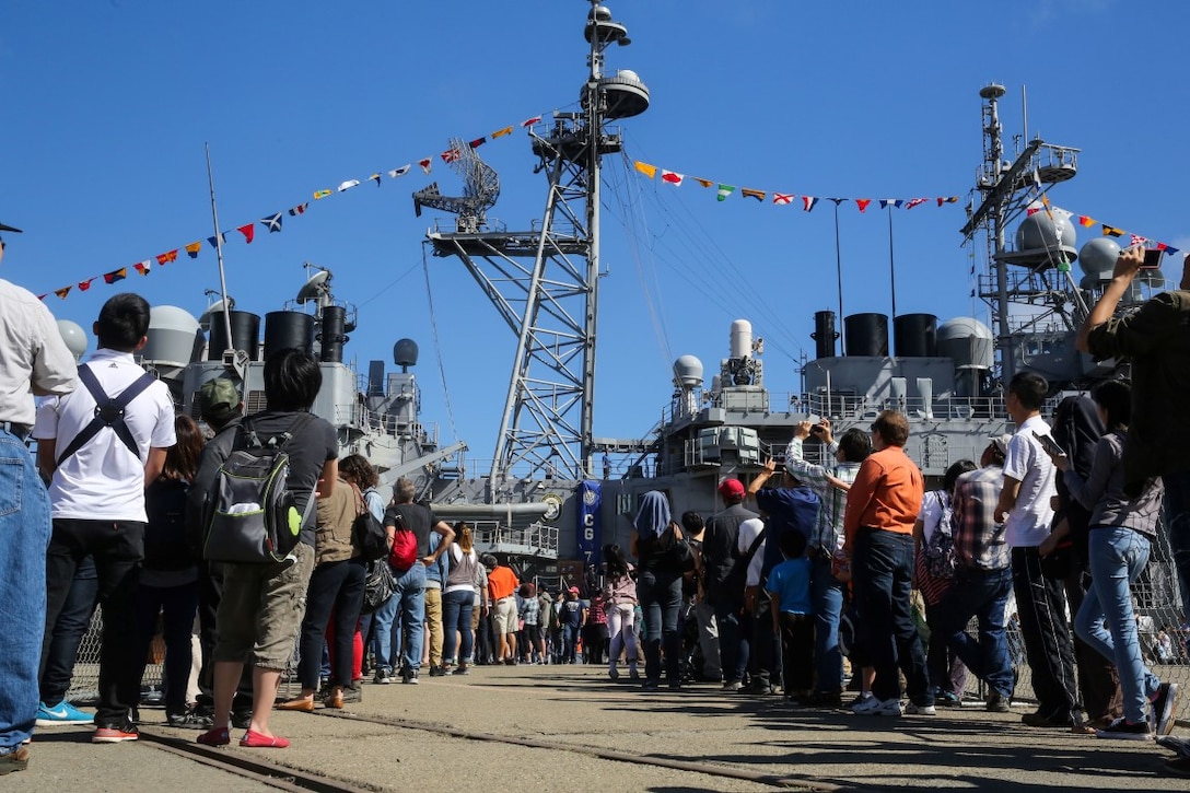 Attendees of a static ship display wait to board USS Cape St. George on Pier 80 as part of San Francisco Fleet Week 2015, Oct. 10. SFFW 15’ is a week-long event that blends a unique training and education program, bringing together key civilian emergency responders and Naval crisis-response forces to exchange best practices focused on humanitarian assistance disaster relief with particular emphasis on defense support to civil authorities.