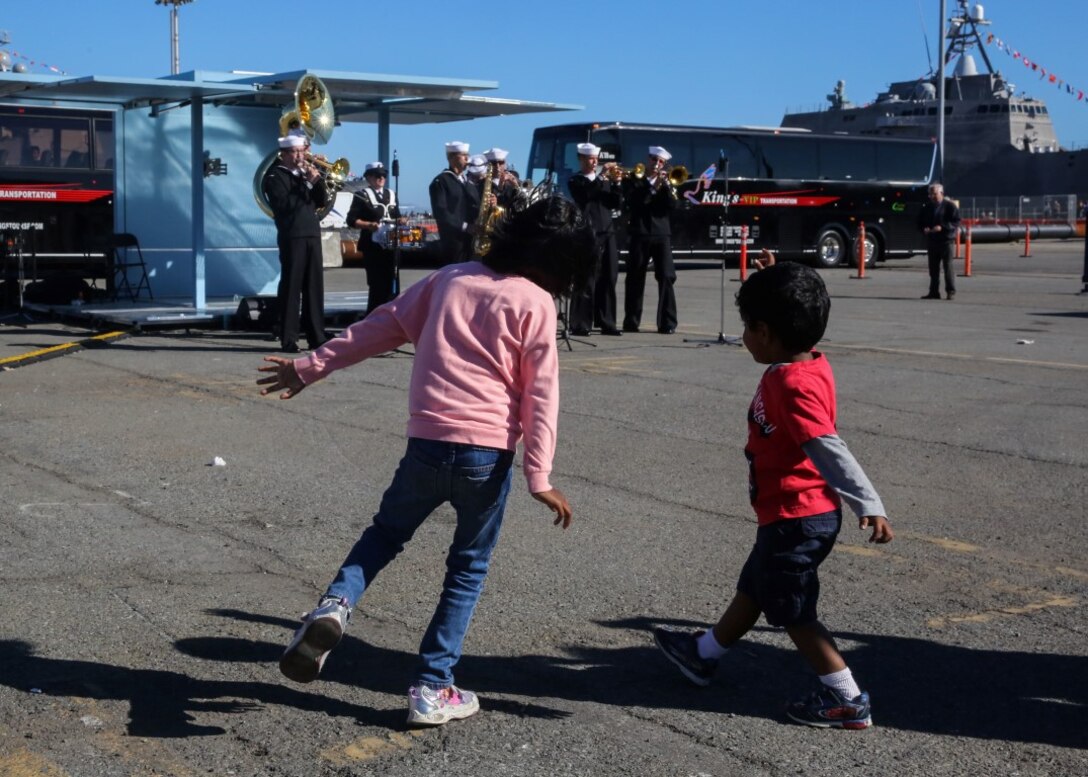 San Francisco children dance to the music of the Navy Southwest Band during a static ship display on Pier 80 as part of San Francisco Fleet Week 2015, Oct. 10. SFFW 15’ is a week-long event that blends a unique training and education program, bringing together key civilian emergency responders and Naval crisis-response forces to exchange best practices focused on humanitarian assistance disaster relief with particular emphasis on defense support to civil authorities.